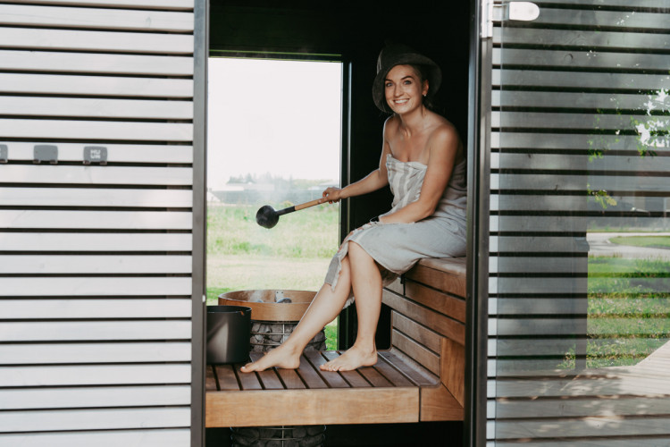 HUUM sauna heater in use in a modern outdoor sauna